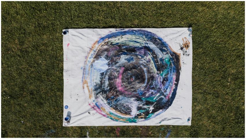 Colorful abstract art on canvas placed on grass, s