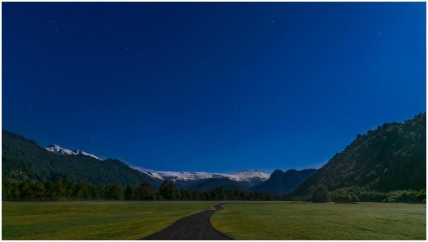 A stunning starry night over the mountains and fie