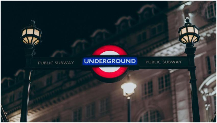 Illuminated London Underground sign with lamp post