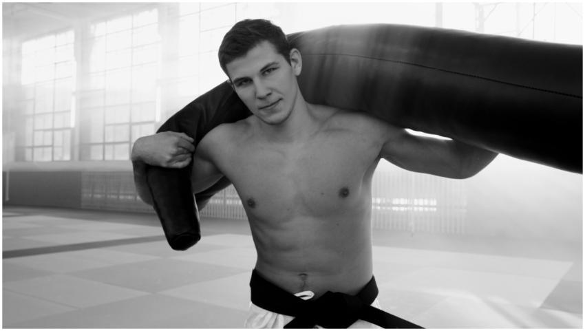 A young male martial artist training indoors with