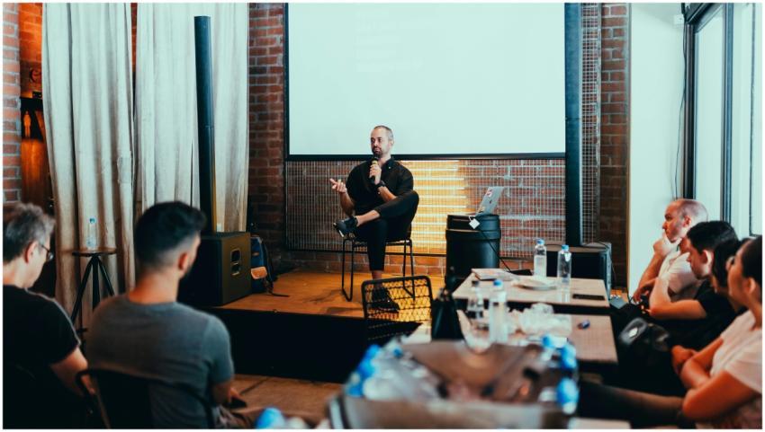 A business seminar with a speaker addressing an at