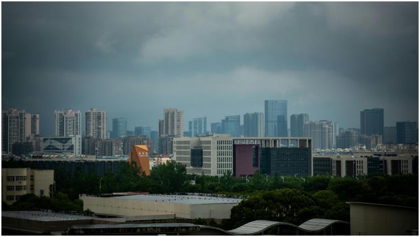A city skyline under dark, overcast skies with mod