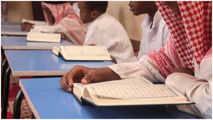 Boys engaging in reading religious texts at a scho