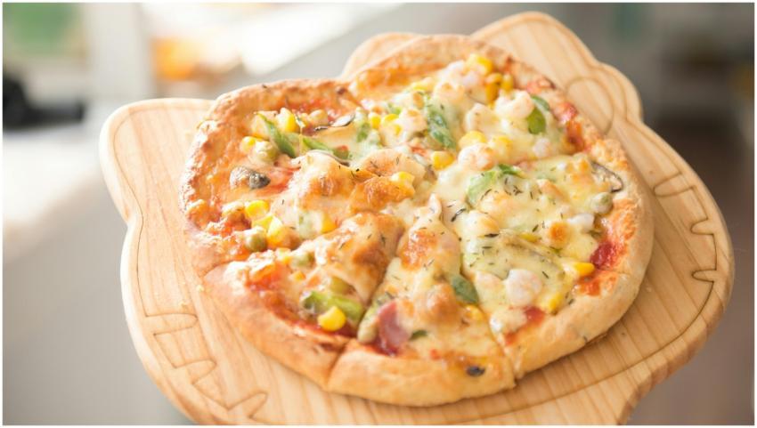 Fresh homemade vegetable pizza topped with cheese