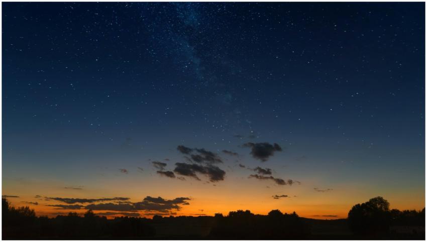 Captivating starry night sky over a silhouette lan