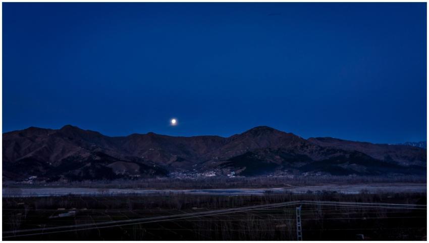 Scenic view of moonlit mountains at night in Kalam