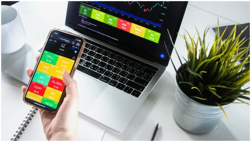 Person analyzing stock market trends on smartphone