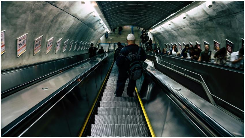 A crowded subway station escalator filled with div