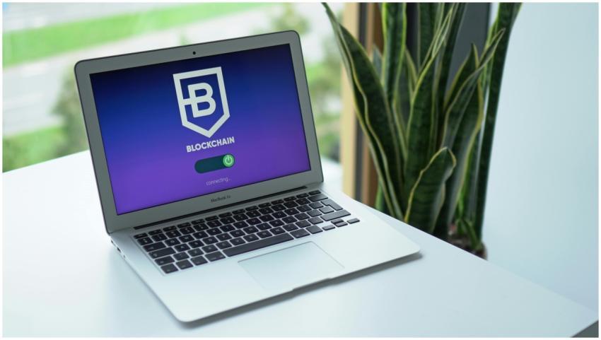 A modern laptop on a desk showing a blockchain int