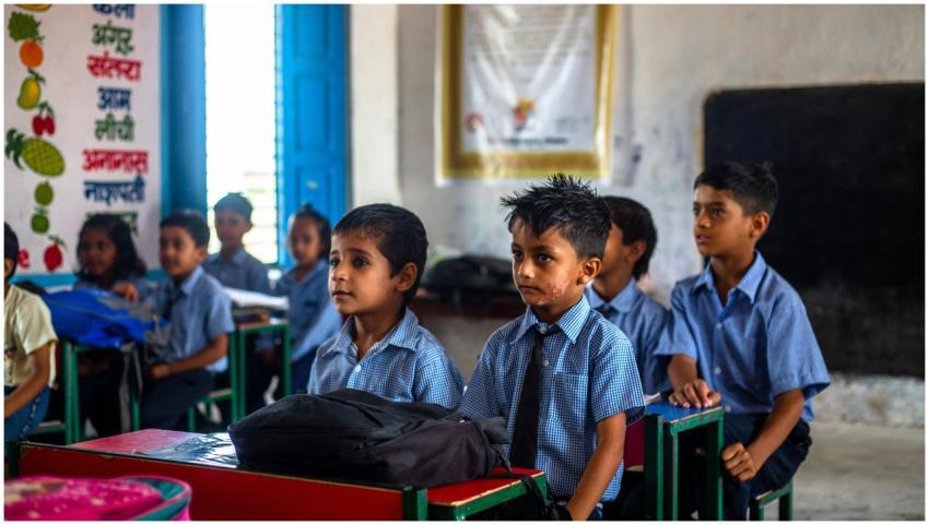 Indian school children in uniforms attentively lis