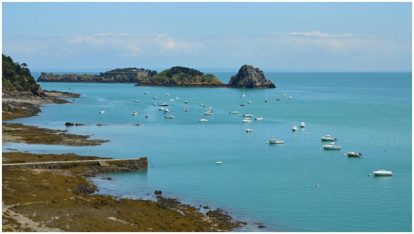Scenic view of boats anchored in a bay with distan