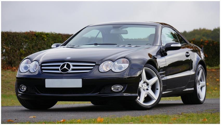 Shiny black Mercedes convertible on an outdoor roa