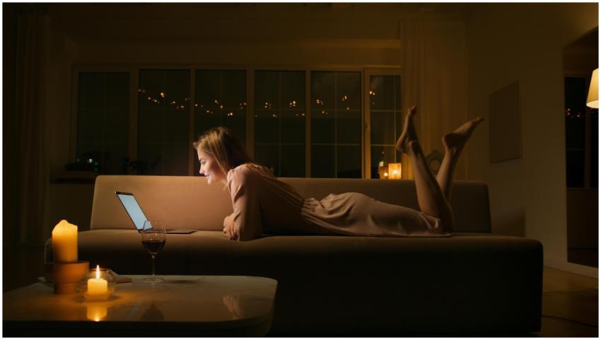 Caucasian woman smiling and relaxing on a sofa wit