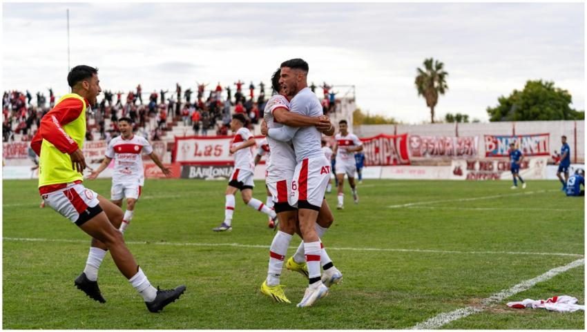 Football players celebrating a goal on the field w