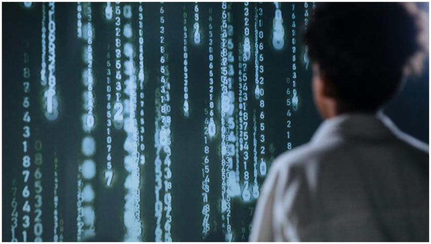 An individual viewing glowing numbers on a screen,