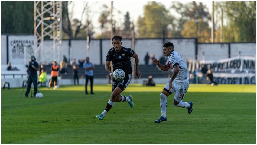 Intense football match action with two players com
