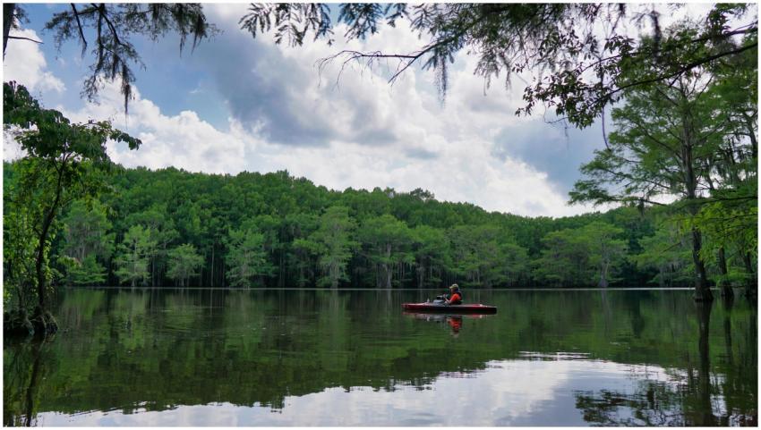 A tranquil scene of a kayaker enjoying the serene