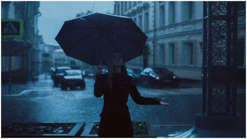 Woman under an umbrella during a rainy day in a mo