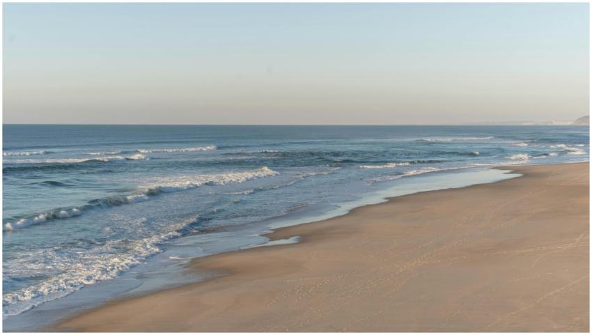 Gentle waves hitting the shore at Nazaré, Portugal