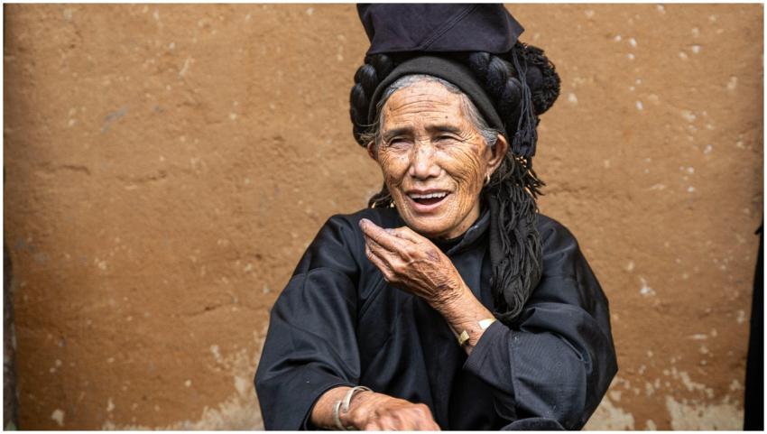 Smiling elderly woman in traditional Vietnamese at