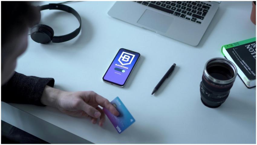 Person holding credit card by digital currency app