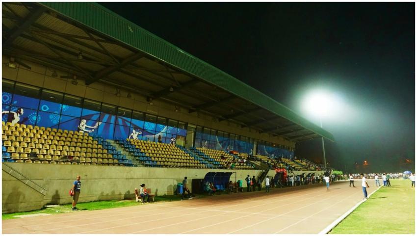 A vibrant night sports event at an outdoor stadium