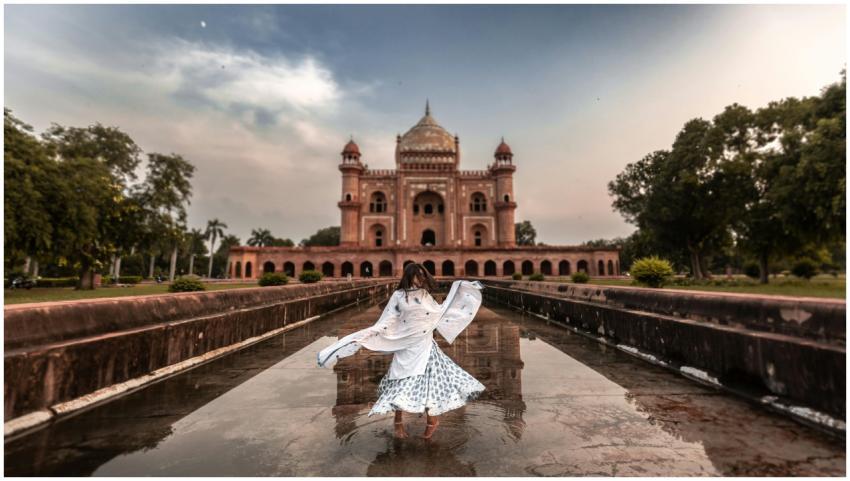 A woman in traditional dress poses in front of Saf