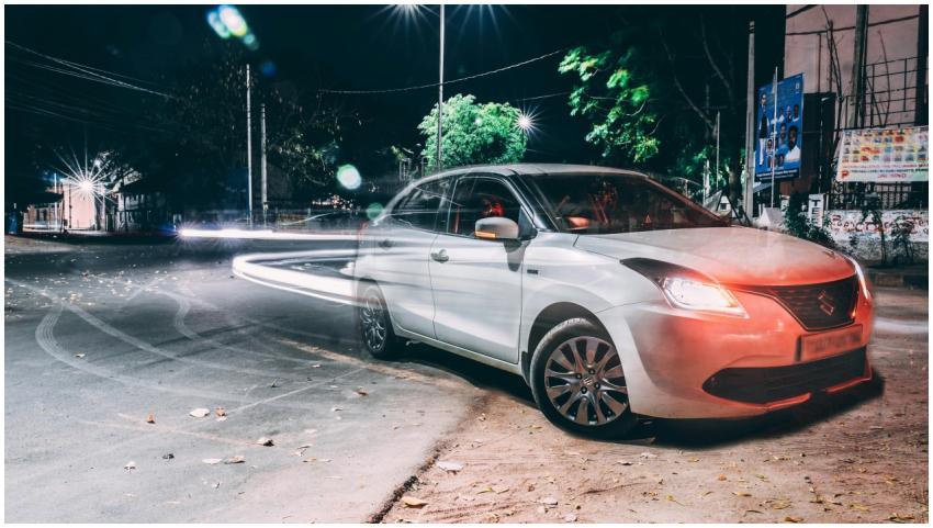 A long exposure night shot capturing a parked car