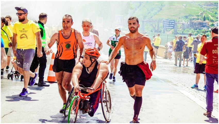 A dynamic scene of athletes, including a wheelchai