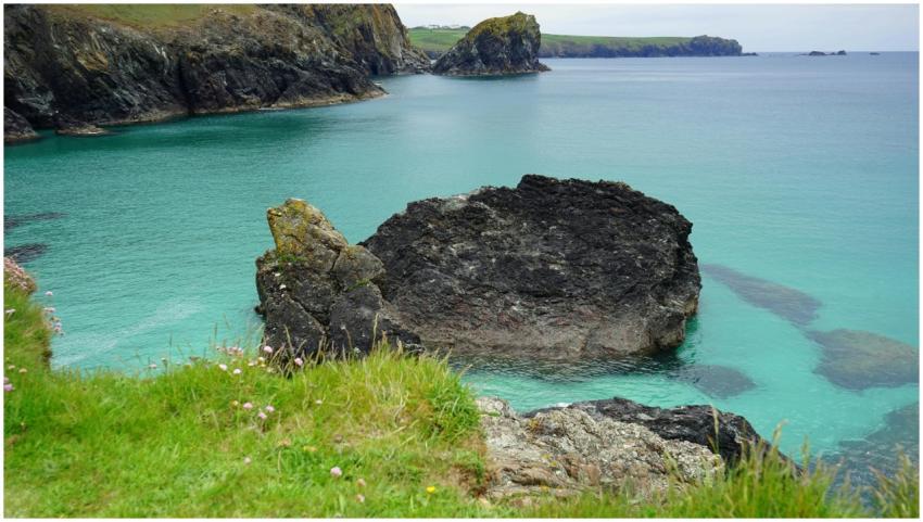 Explore a serene rocky coastline with vibrant turq