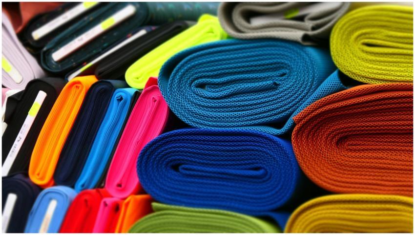 Colorful fabrics neatly rolled and displayed in a