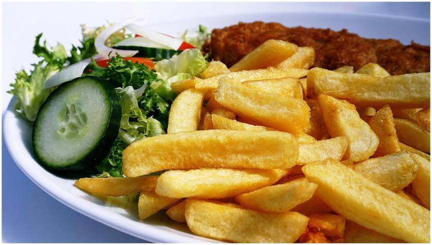 Golden fish and chips served with a fresh cucumber
