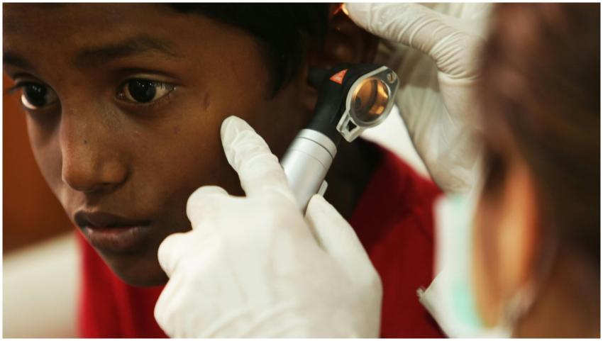 A young boy undergoes a routine ear examination by
