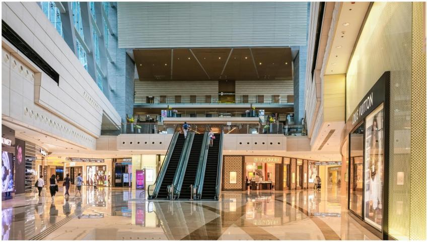 Modern shopping mall interior with escalators and