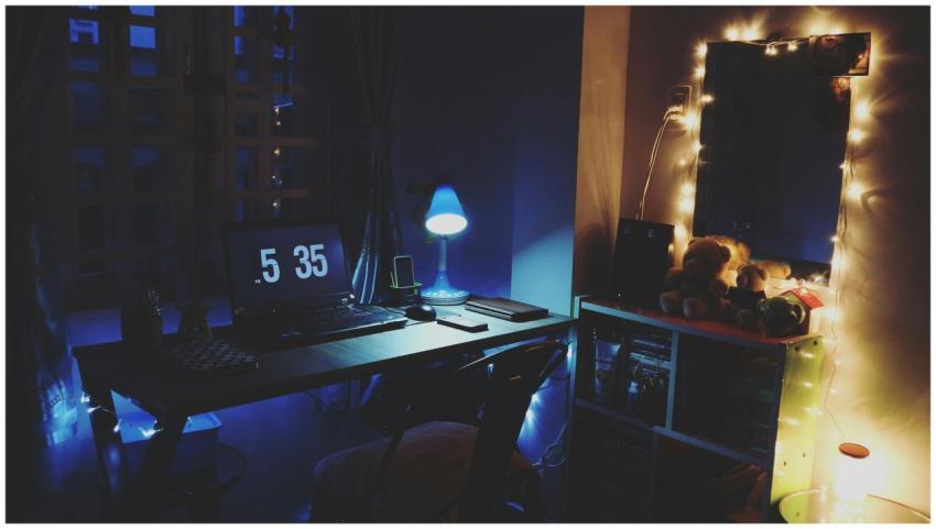 A warmly illuminated desk by night, featuring a la