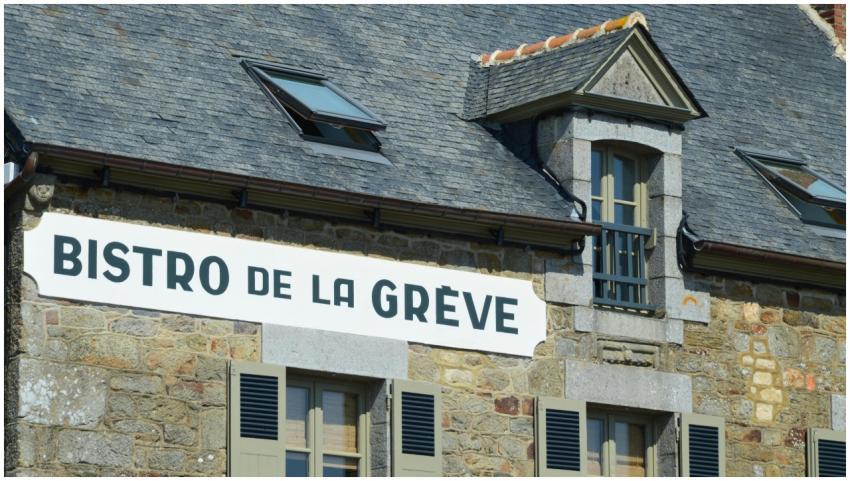 Rustic stone bistro facade with French signage in