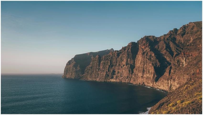 Breathtaking view of a rugged cliff meeting the se