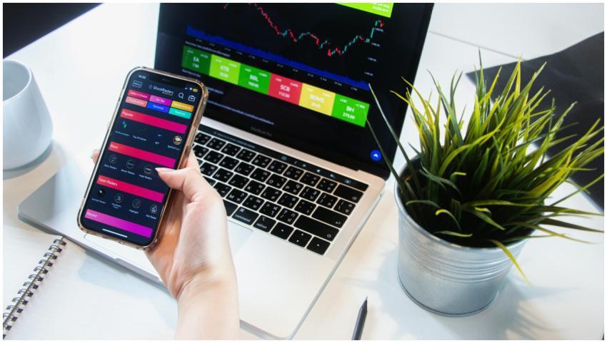A person using a smartphone app to trade stocks wi