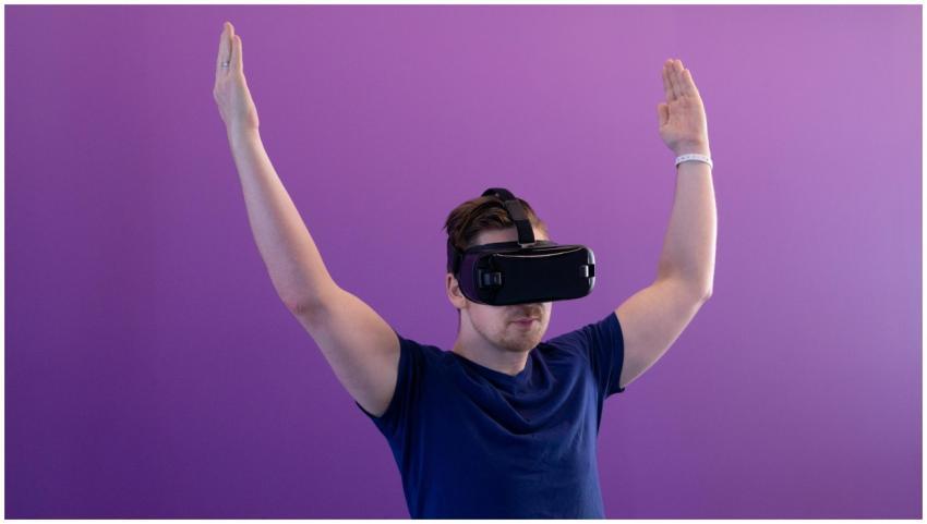 A young adult wearing a VR headset, interacting wi