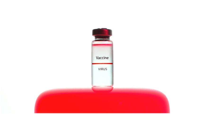 Close-up of a labeled vaccine vial against a vibra