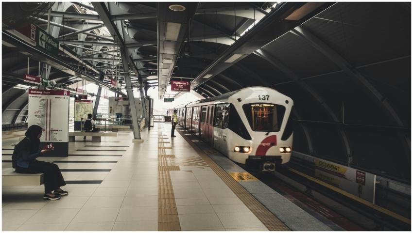 Passenger waiting for a train at a modern railway