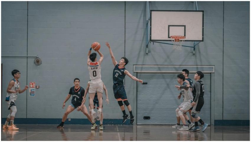 A dynamic indoor basketball game scene featuring p