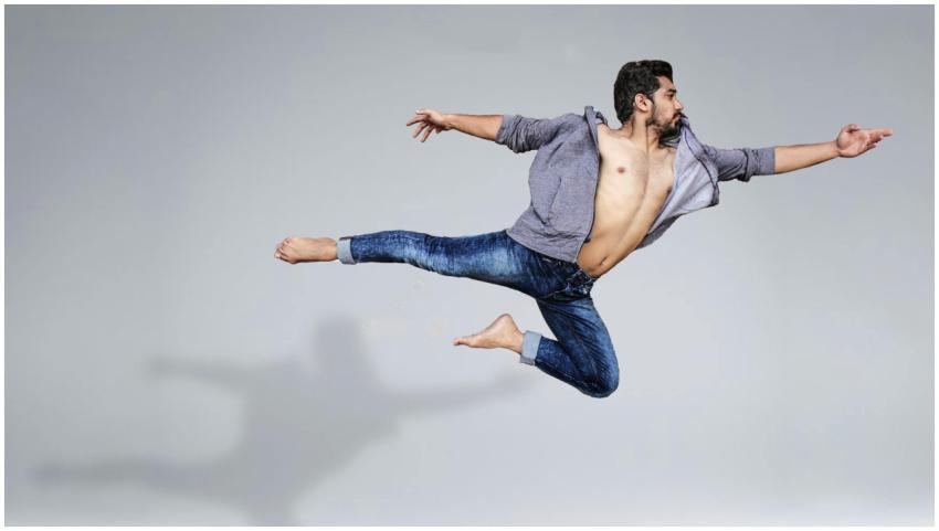 Energetic jump of a male dancer showcasing flexibi