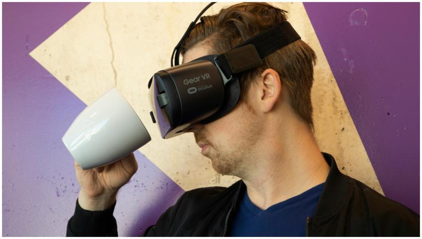 A man using a virtual reality headset while preten