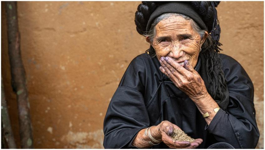 Smiling elderly woman in black traditional attire