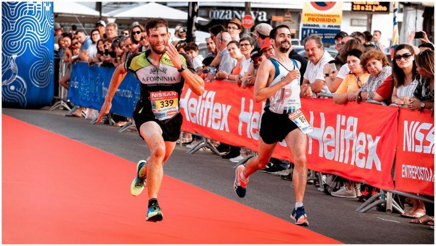 Two marathon runners sprint towards the finish lin
