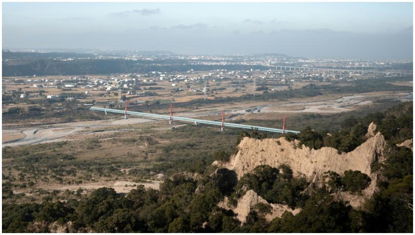 Aerial view of a bridge spanning across a vast lan