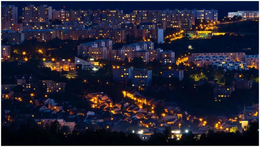 A glowing cityscape at night, showcasing lit windo