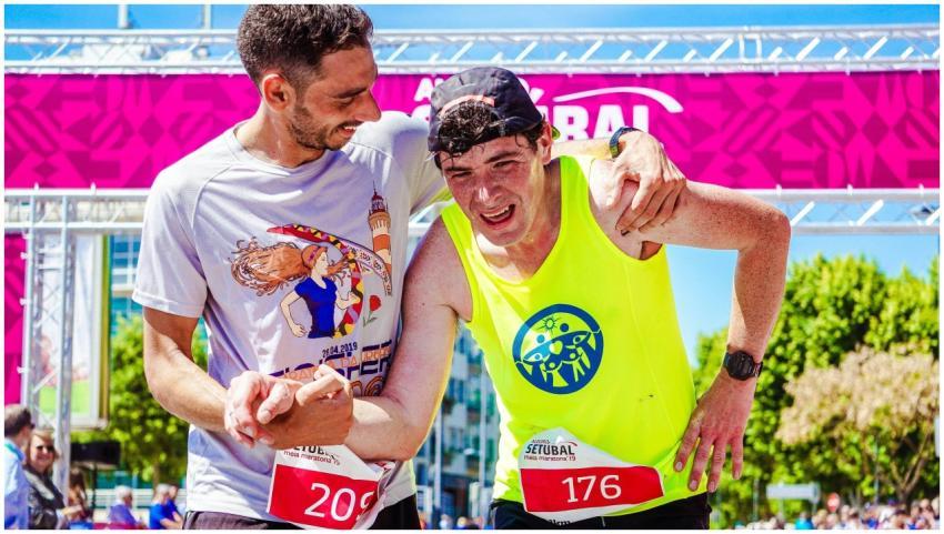 Two athletes celebrate finishing a marathon, highl