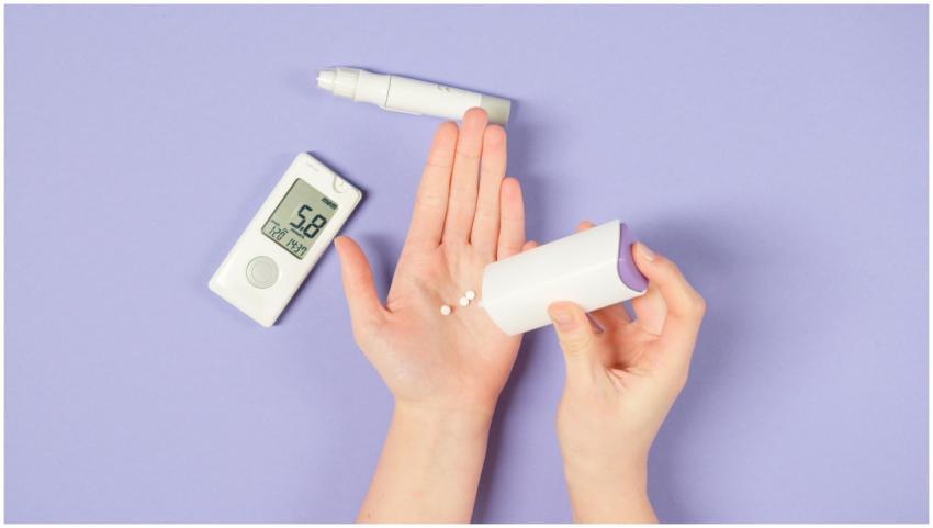 Close-up of hands using diabetes tools with a gluc